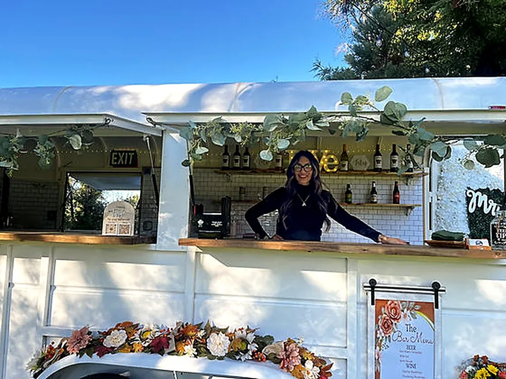The Saddle Up trailer bar dressed with greenery and florals